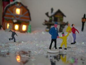 Christmas village people skating in the miniature Christmas village