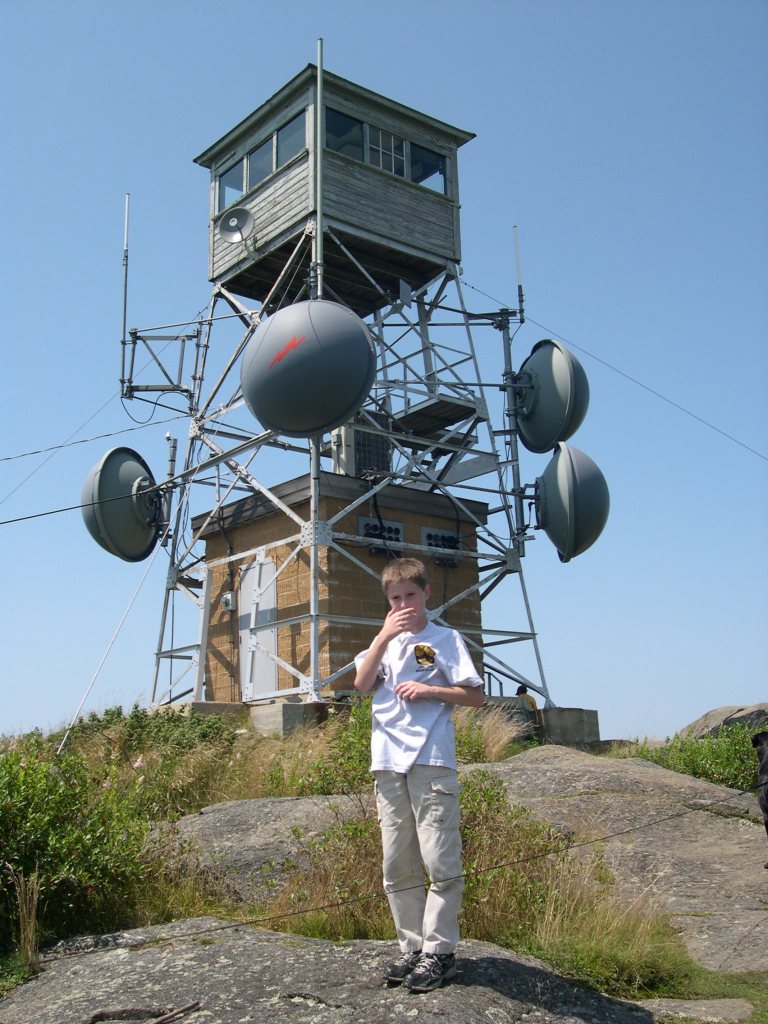 fire tower on Pitcher Mountain with my 10 year old son on the rocks.