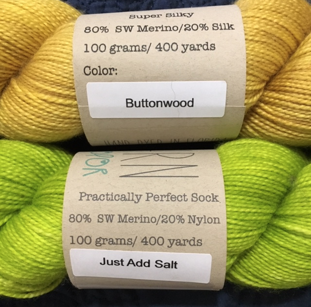 Yellow and green skeins of Emma's yarn from the Four Purls yarn shop truck.