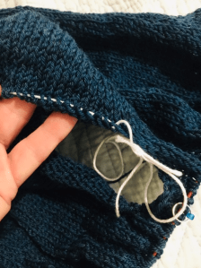 Armhole stitches are on hold while I continue working the body.