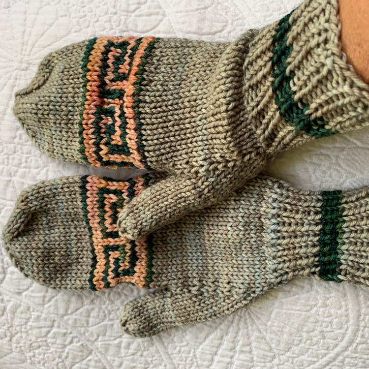 Pair of hand-knit mittens with Greek key pattern