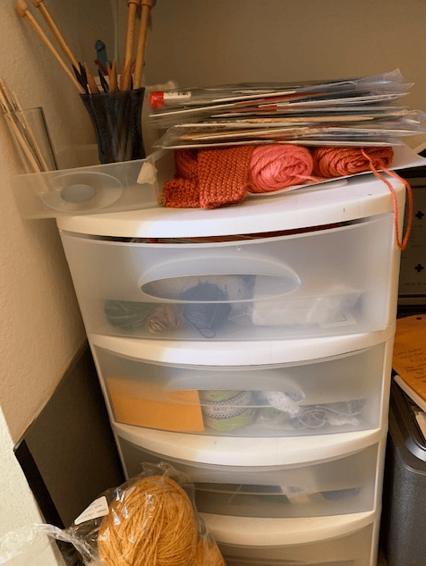 Plastic bin storing knitting supplies