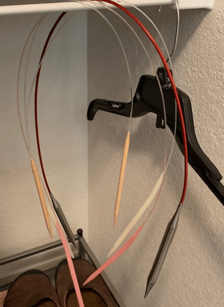 Circular knitting needles hanging in closet