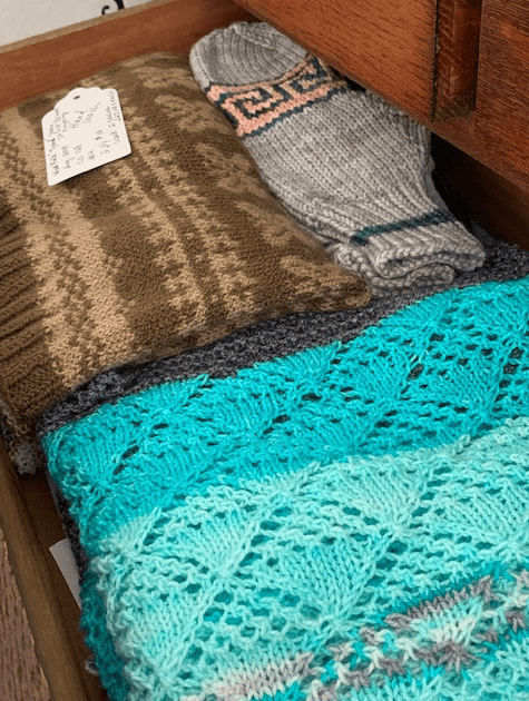 hand knit items in a bureau drawer
