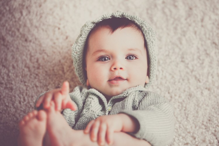 Baby in matching knitted hat and sweater
