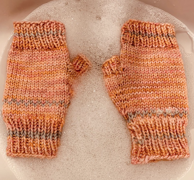 Orange fingerless mitts in Malabrigo