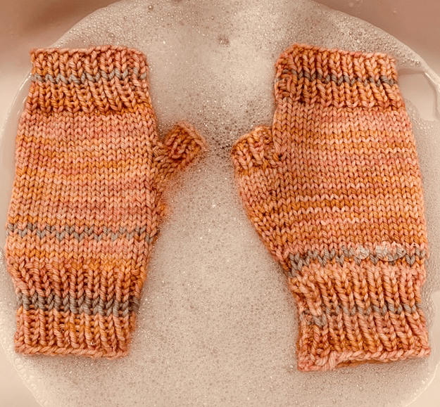 Orange fingerless mitts in Malabrigo