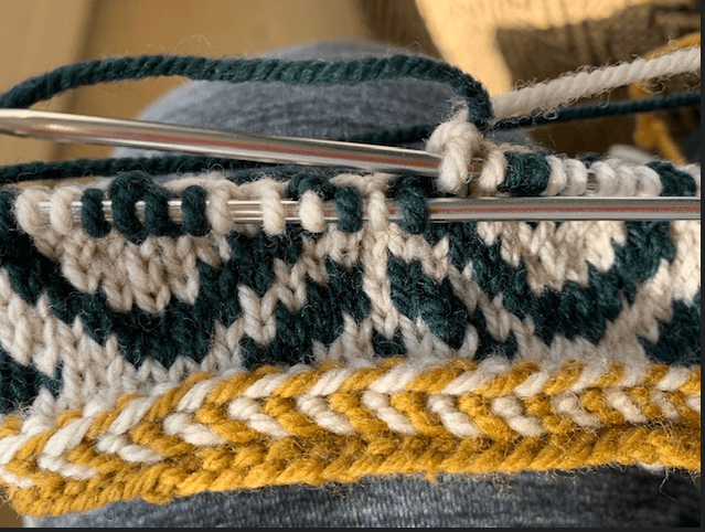 Fiddlehead mittens cast on Latvian Braid