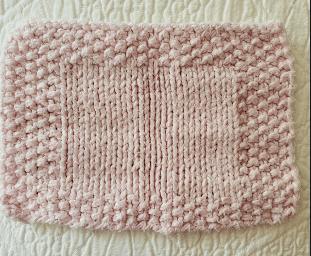 pink hand-knit facecloth