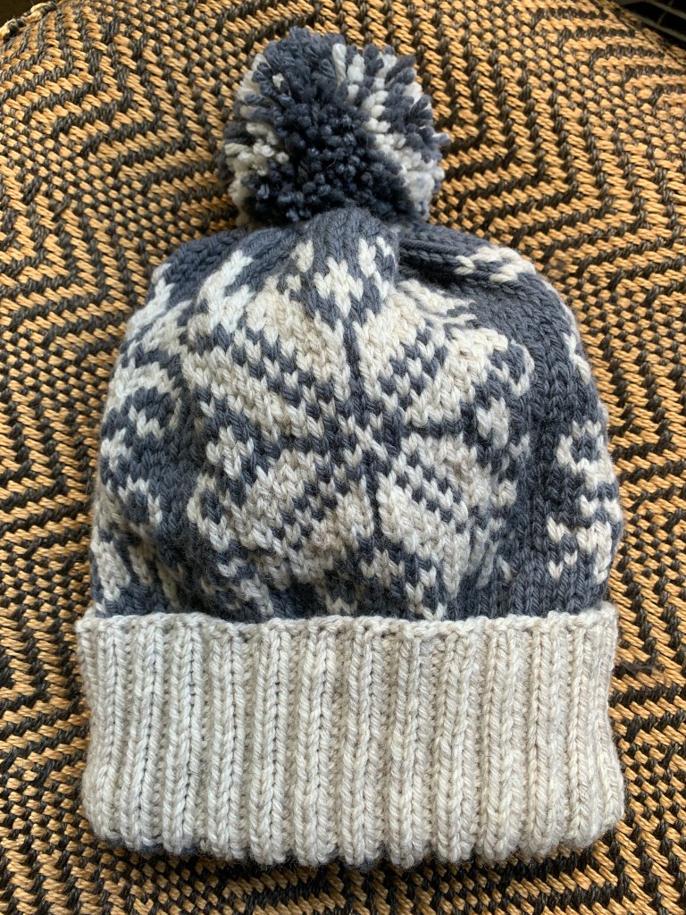 Curly Snowflake colorwork hat with pompom, in gray and off-white