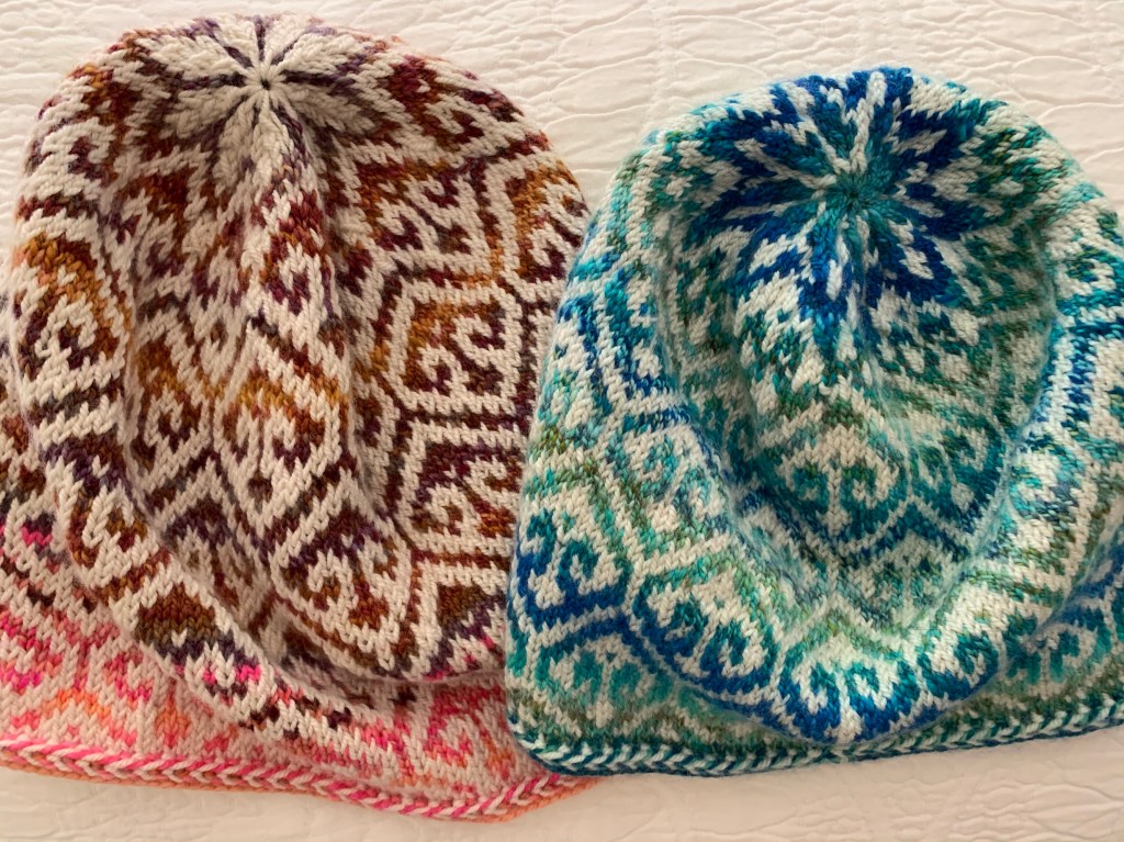 Blue and brown versions of the hand-knit caps
