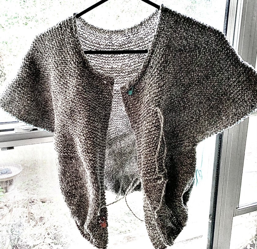Cobblestone Cardigan hanging partially done knitting