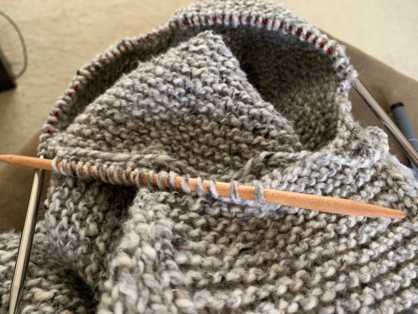picking up stitches to begin knitting the sweater sleeve