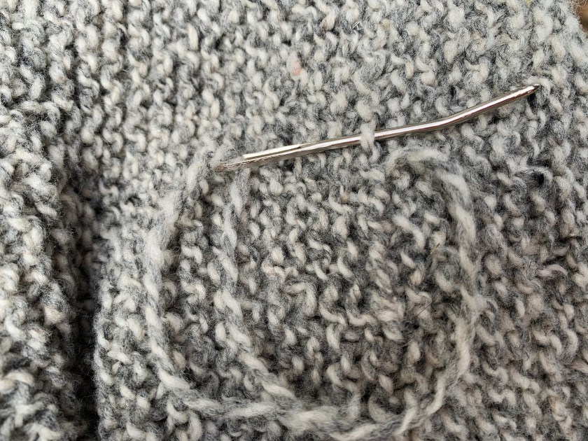 Weaving in ends on my Cobblestone Cardigan