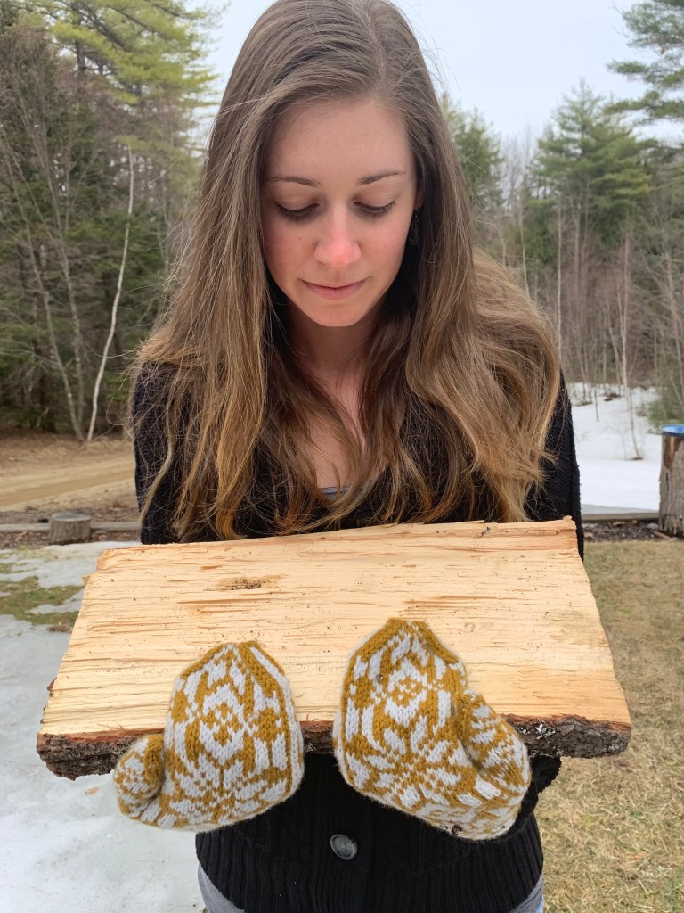 Carrying wood with hand knit mittens