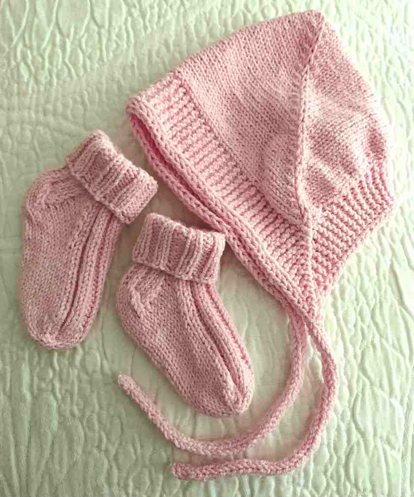 Knitting baby set with bonnet and socks