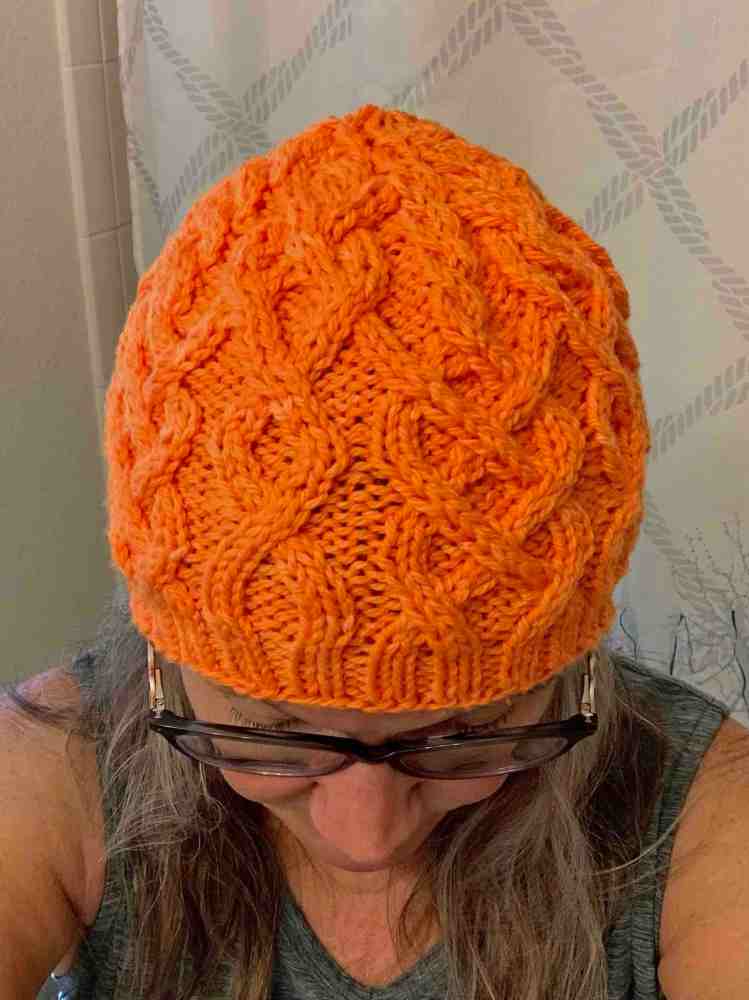 wearing new hand knit beanie with cables