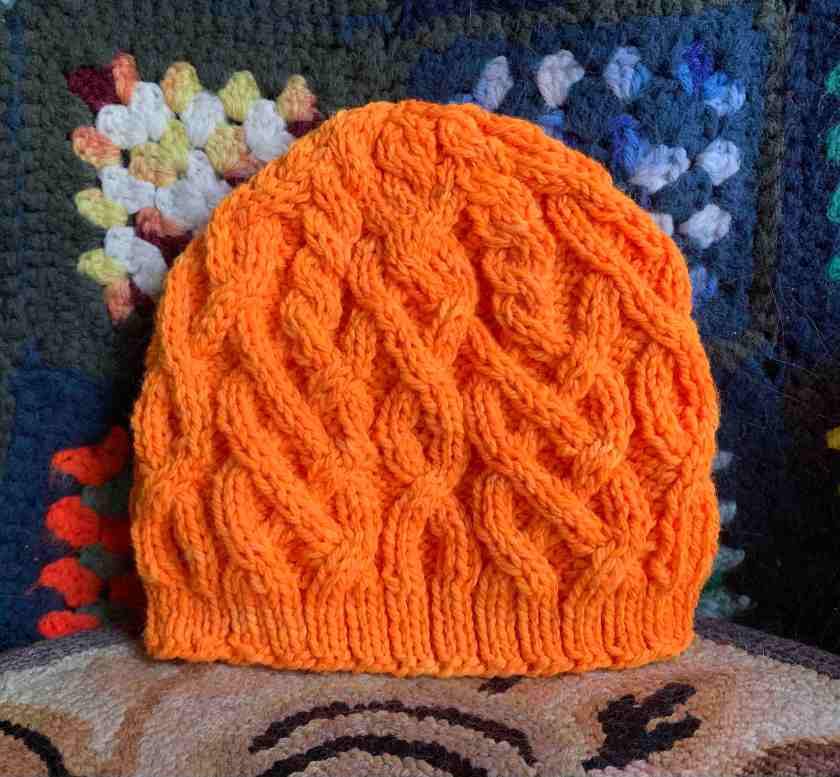 Cabled beanie in bright orange Habitat pattern