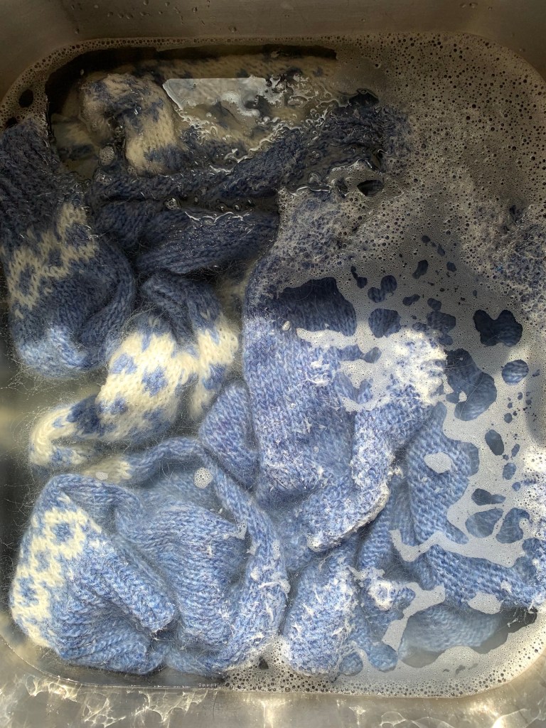 blue sweater soaking in wash
