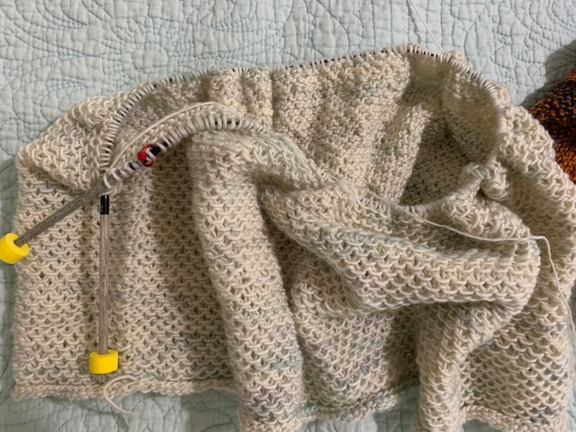 circular knitting the Honey Cowl in off-white