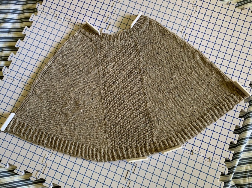 Hand knit poncho drying