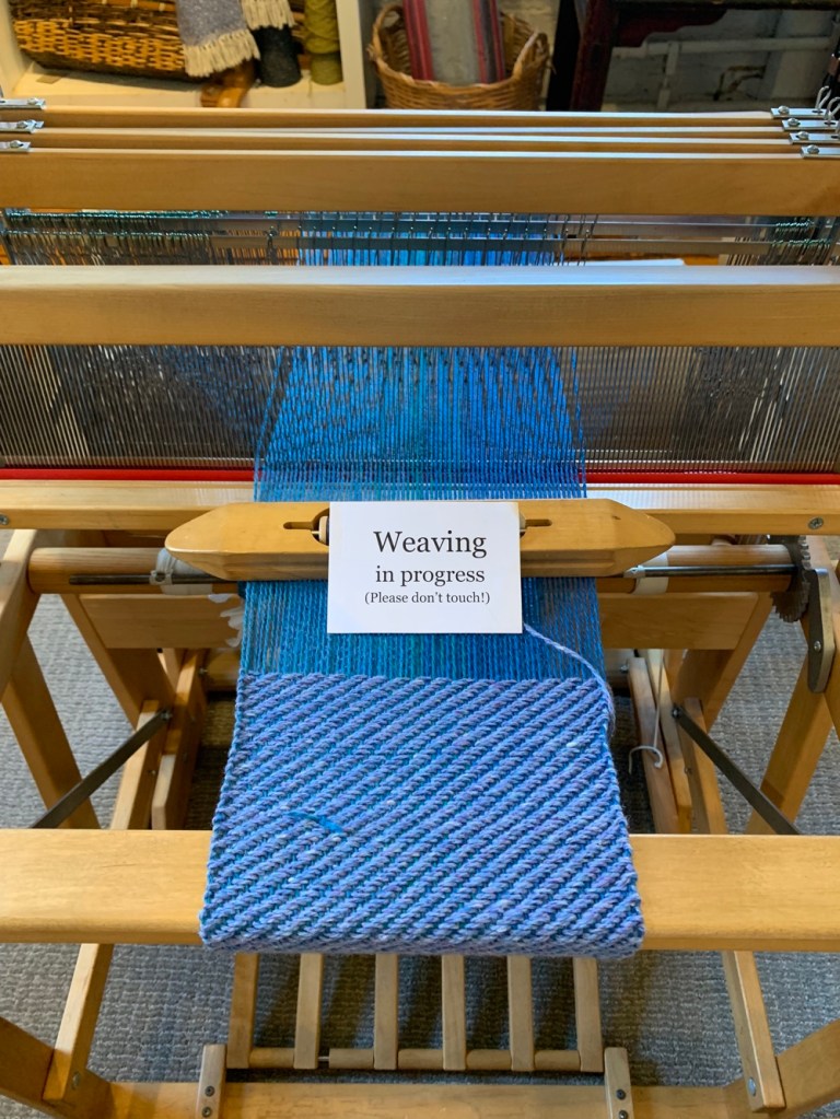 loom weaving blue yarn