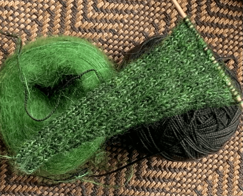 Alex scarf knitting project in green yarn