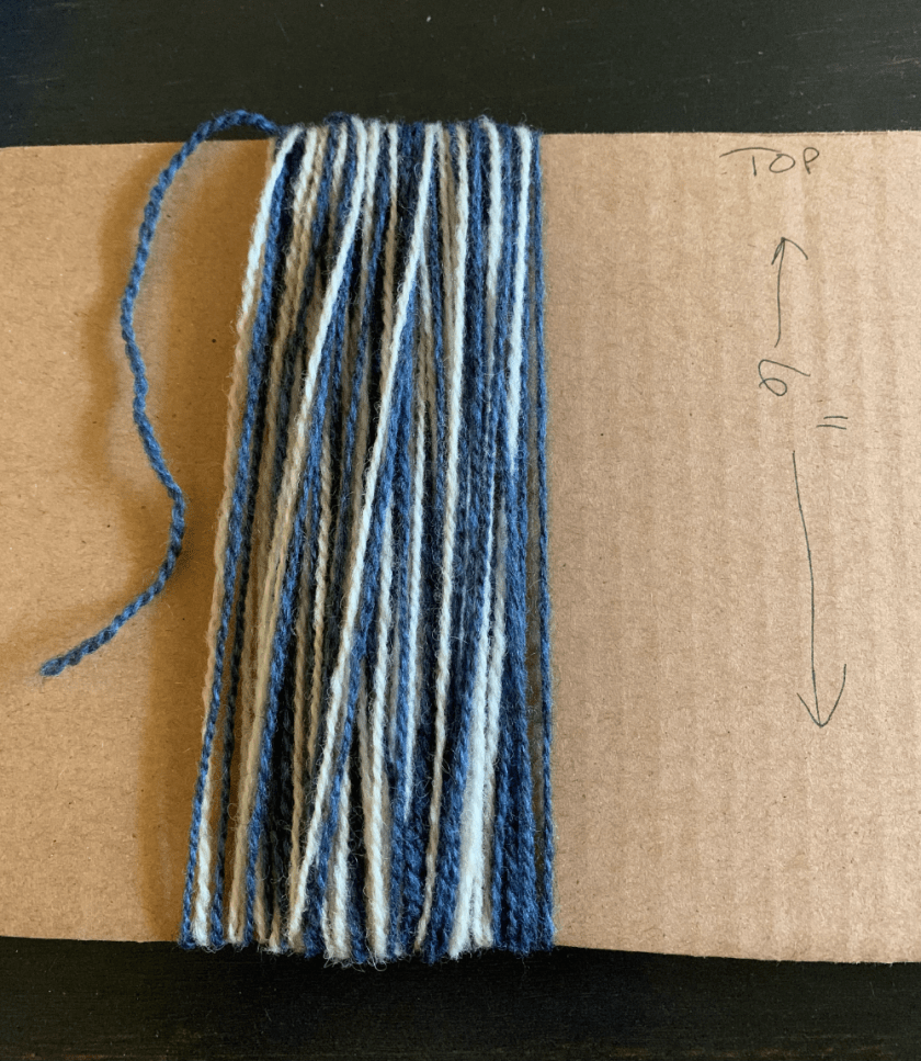 wrapping blue and white yarn for making a tassel