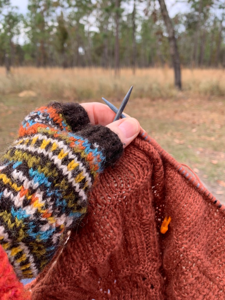Knitting in nature while wearing fingerless mitts.  